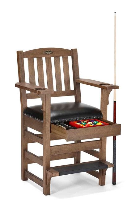 Brunswick Centennial Player’s Chair in Rustic finish shown at a three-quarter angle on a white background with the hidden drawer fully open, revealing a complete Brunswick Centennial billiard ball set and chalk. Built-in cup holders, cue notches, and black footrest protector highlight the chair’s functional design for luxury game rooms.

