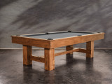 The Nixon Billiards Presli Slate Pool Table is beautifully staged in a contemporary entertainment space, featuring warm natural light, wood flooring, and curated decor. The table’s Natural Acacia finish adds an organic touch to the room, creating a high-end look perfect for both casual gatherings and upscale hosting. Styled exclusively for Sawyer Twain’s luxury lineup.

