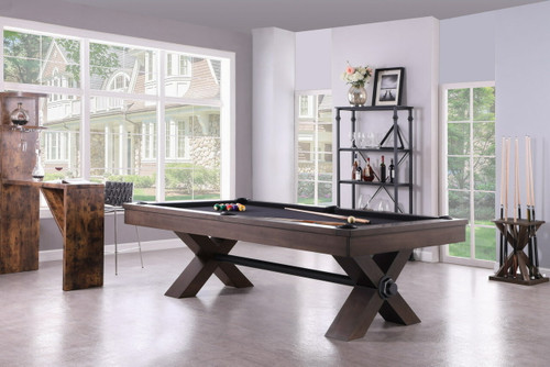 A front-facing shot of the Plank & Hide Voxwood Slate Pool Table in Smoke Walnut, featuring the X-leg design and oversized bolts for a bold industrial look, and a sleek black stretcher for added design appeal.